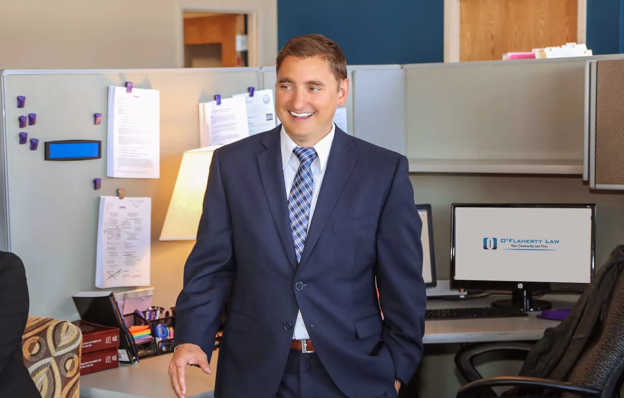 An attorney seated in a professional office setting