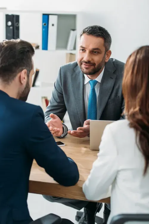 An attorney reviewing documents with a client across a desk